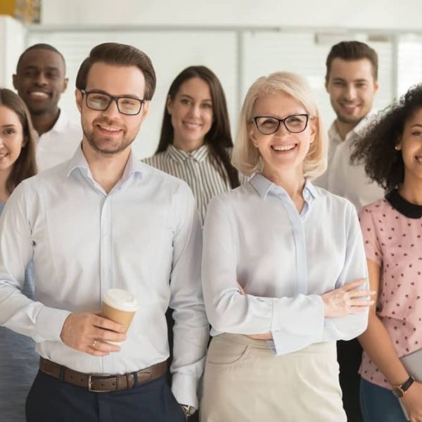 Smiling professional business leaders and employees group team portrait